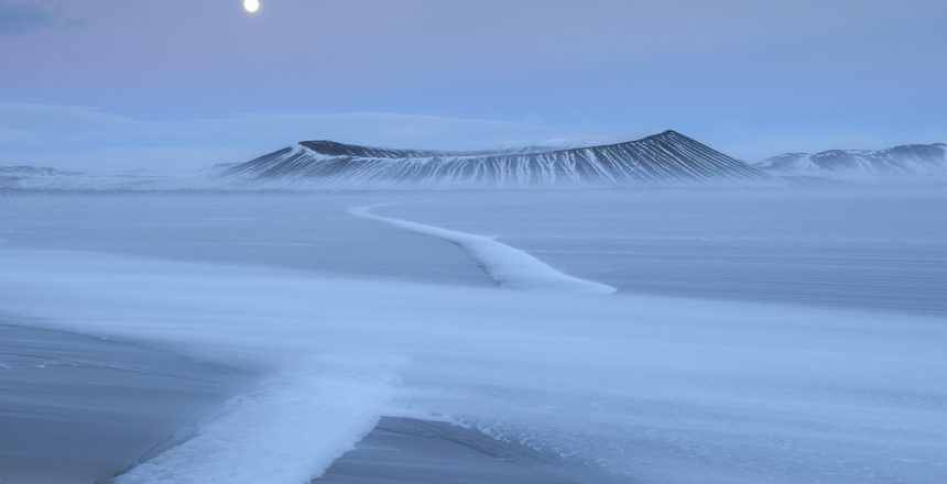 The crater of Hverfjall with the frozen Myvatn in the foreground. Full Moon. Iceland.